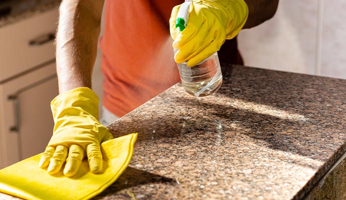 person-cleaning-counter-top